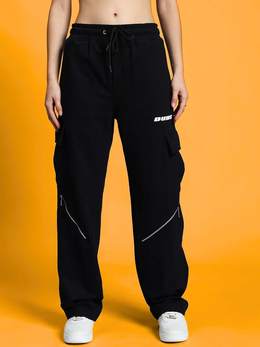 Woman wearing WOMEN'S STUPEFY CO-ORD SET MAROON-BLACK with premium heavy gauge fabric joggers on an orange background.