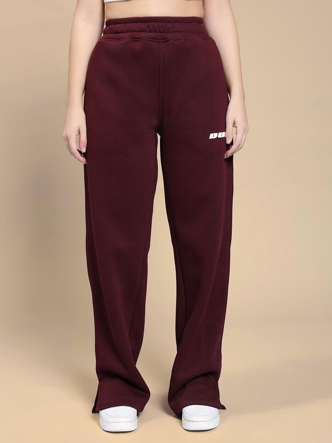 Woman wearing WOMEN SKODA FLEECE CO-ORD SET MAROON with stylish maroon pants standing against a plain background.