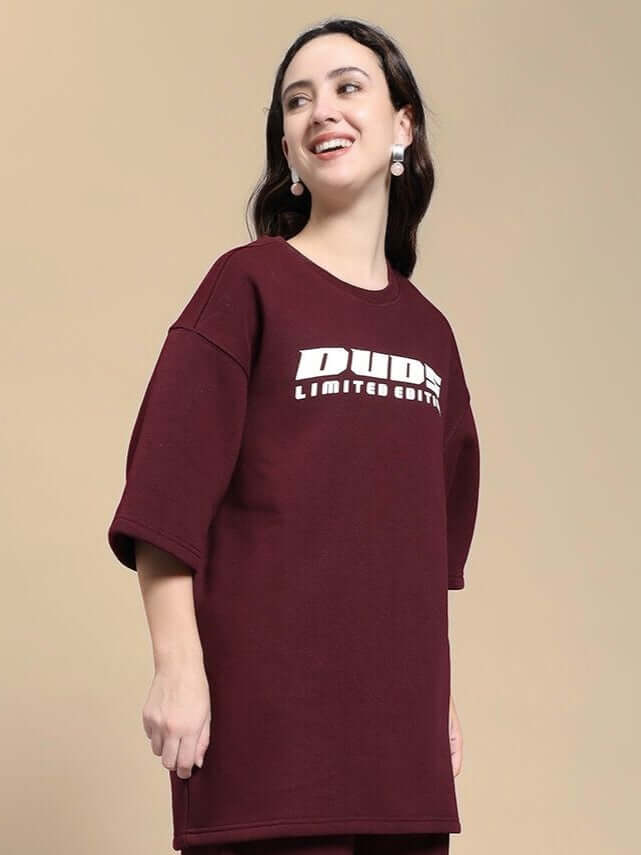 Woman wearing WOMEN SKODA FLEECE OVERSIZED T-SHIRT MAROON showcasing modern casual style.