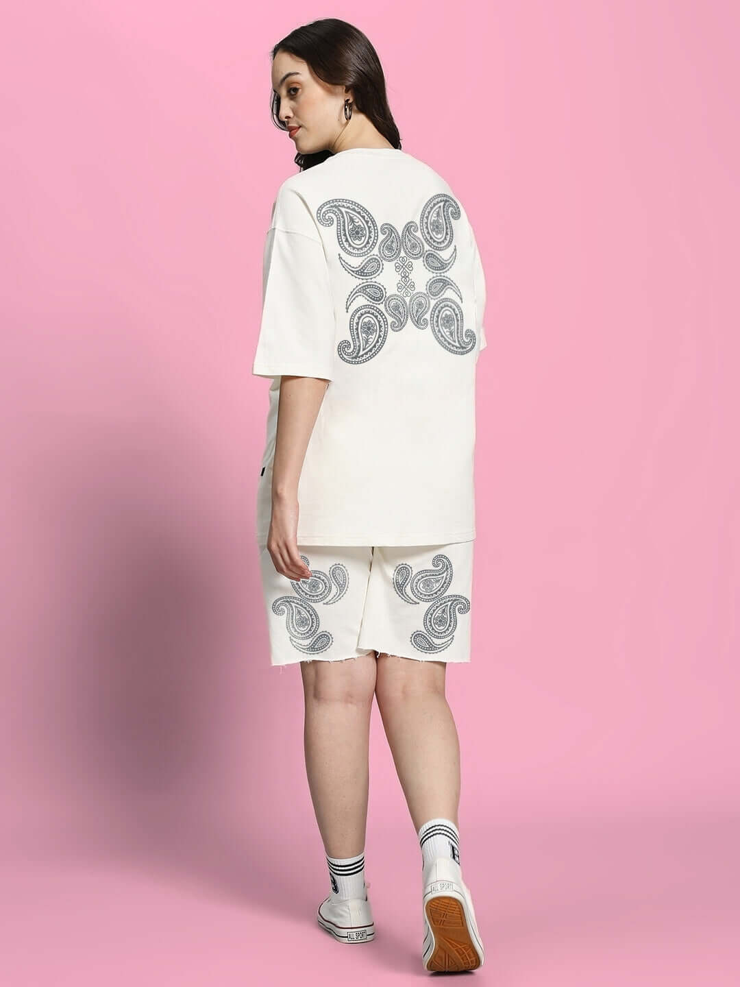 Model wearing WOMEN'S MESSI PAISLEY PRINT CO-ORD SET OFF WHITE with oversized paisley t-shirt and matching shorts.