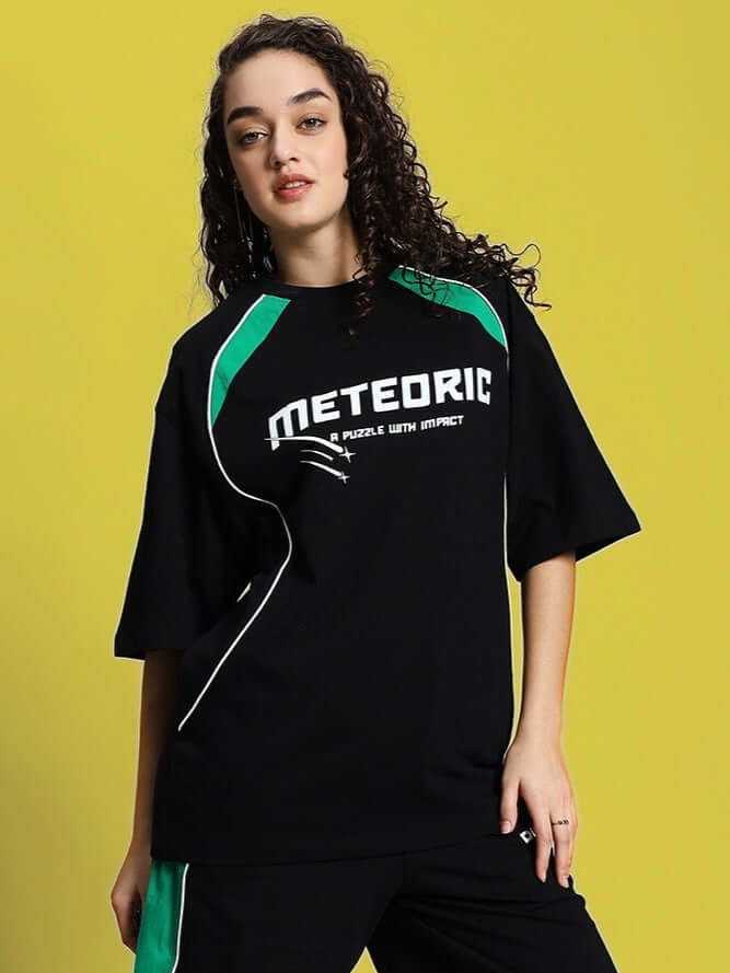 Women's black oversized Meteoric T-shirt in premium cotton, styled with green accents. Perfect for casual wear. Made in India.