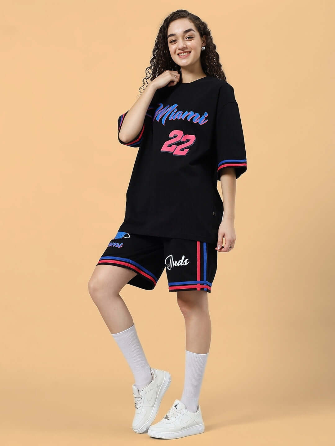 Woman wearing WOMEN'S MIAMI COLORBLOCK CO-ORD SET BLACK with bold Miami print, featuring cotton terry fabric, in stylish pose.