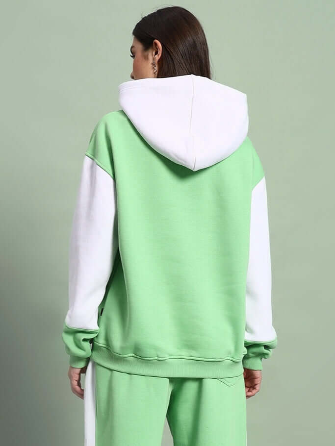 Back view of WOMEN MINTED BLISS FLEECE COLORBLOCK HOODIE GREEN WHITE showcasing design and fit.