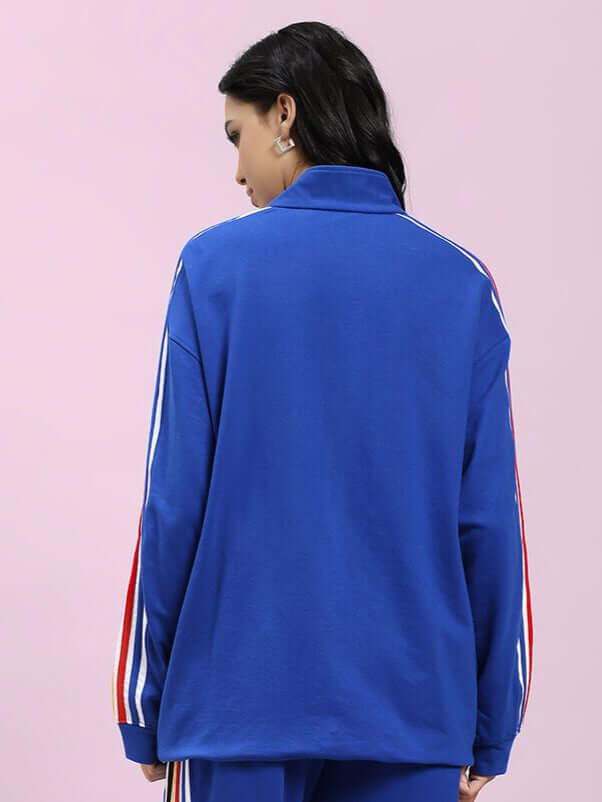 Back view of WOMEN MODERN EDGE MULTI-STRIPE JACKET ROYAL BLUE with sleek multi-stripe detailing on sleeves, perfect for sporty sophistication.