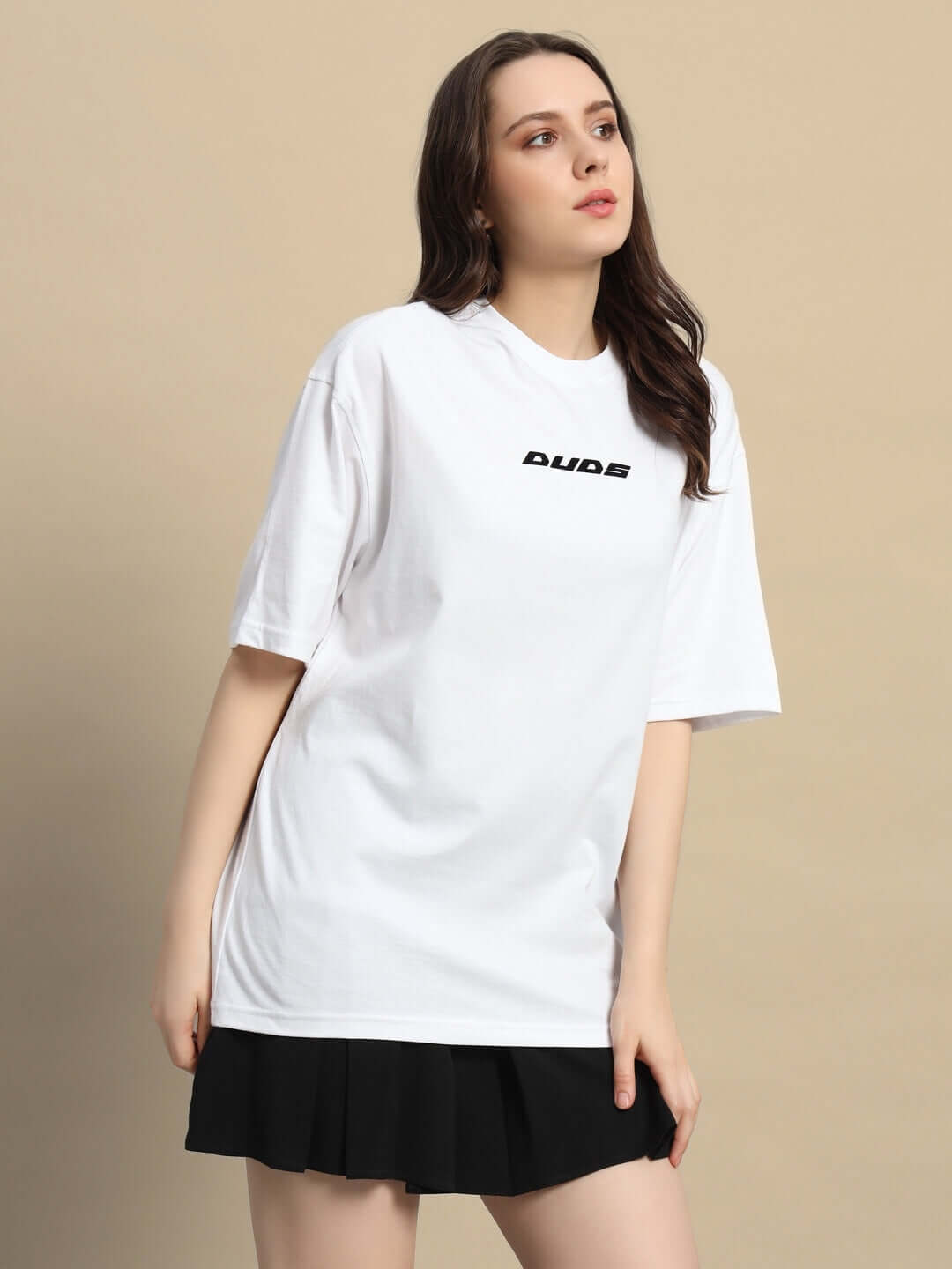 Model wearing a women's oversized white t-shirt made of heavy gauge fabric with black text design.