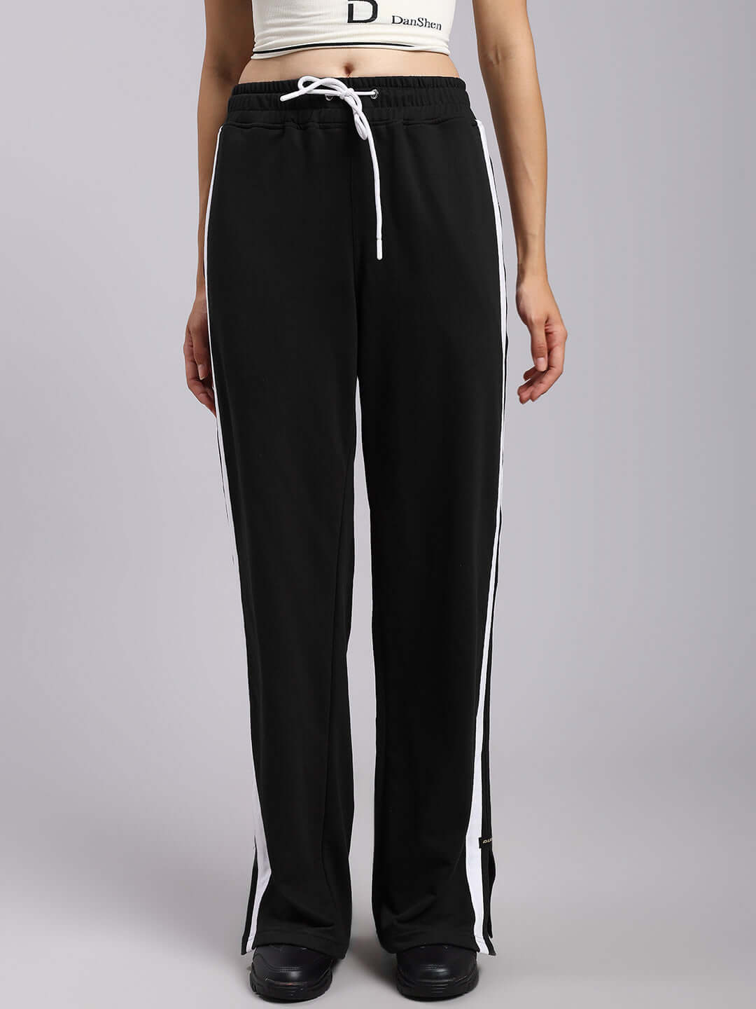 Black women's Moscow relaxed fit joggers with white stripes, made to order by experienced tailors, available in customizable sizes.