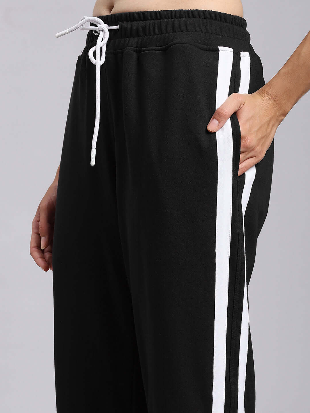 Close-up of WOMENS MOSCOW RELAXED FIT JOGGERS BLACK with white stripes.