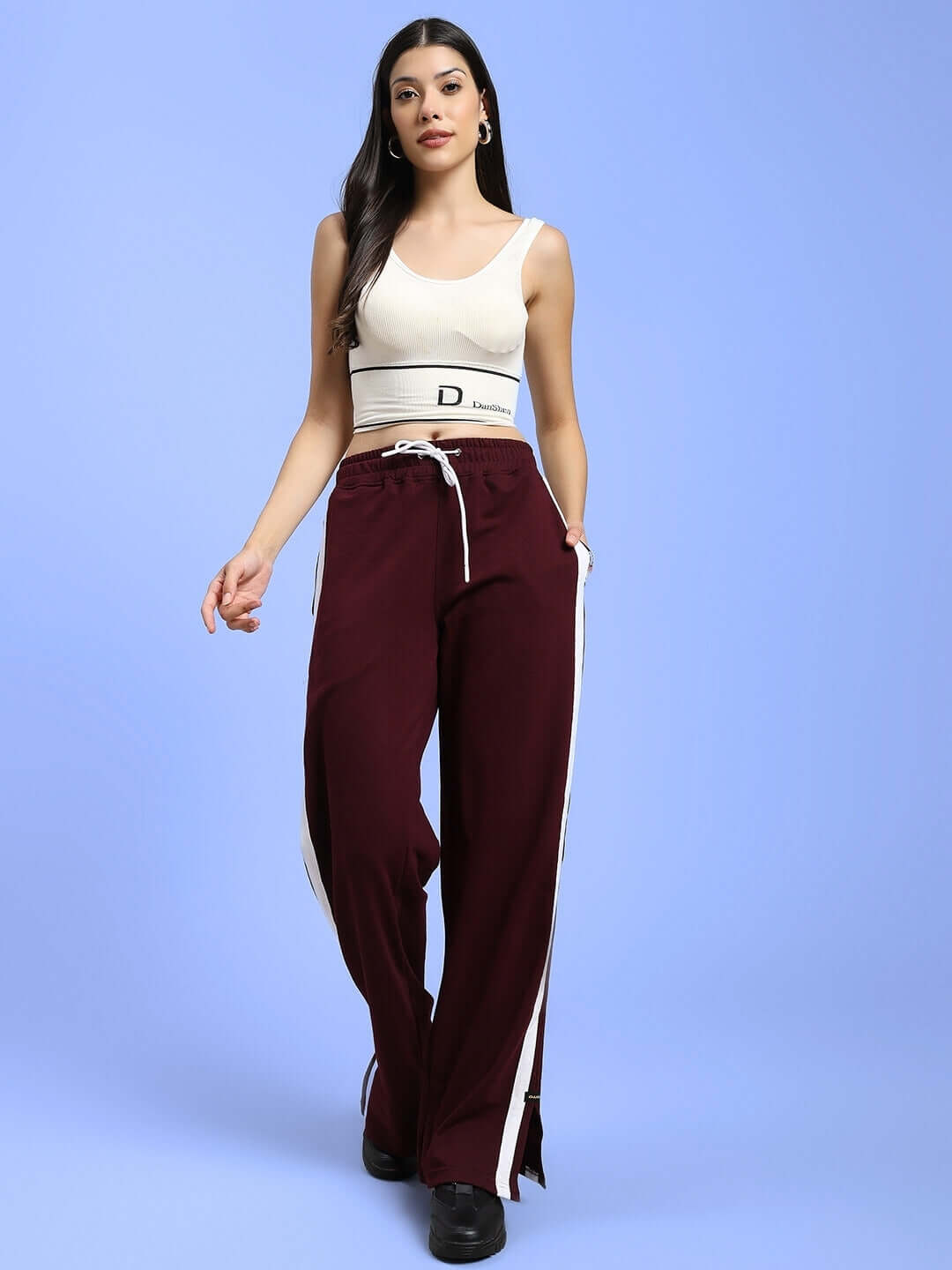 Model wearing maroon Women's Moscow Relaxed Fit Joggers, styled with a white crop top, showcasing casual yet chic fashion style.