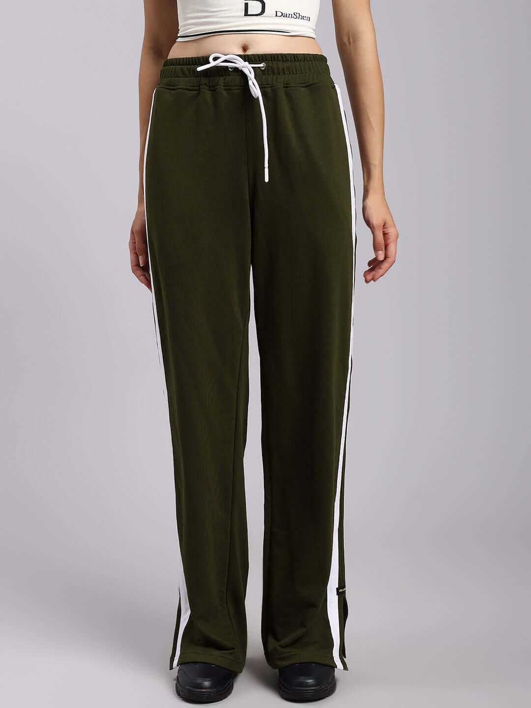 Women's olive green joggers with relaxed fit, elastic waistband, and side stripes, made to order by DUDS tailors.