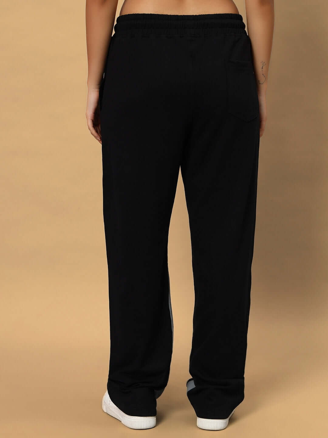 Back view of women's scale relaxed fit joggers in black, showcasing a comfortable and casual design suitable for everyday wear.