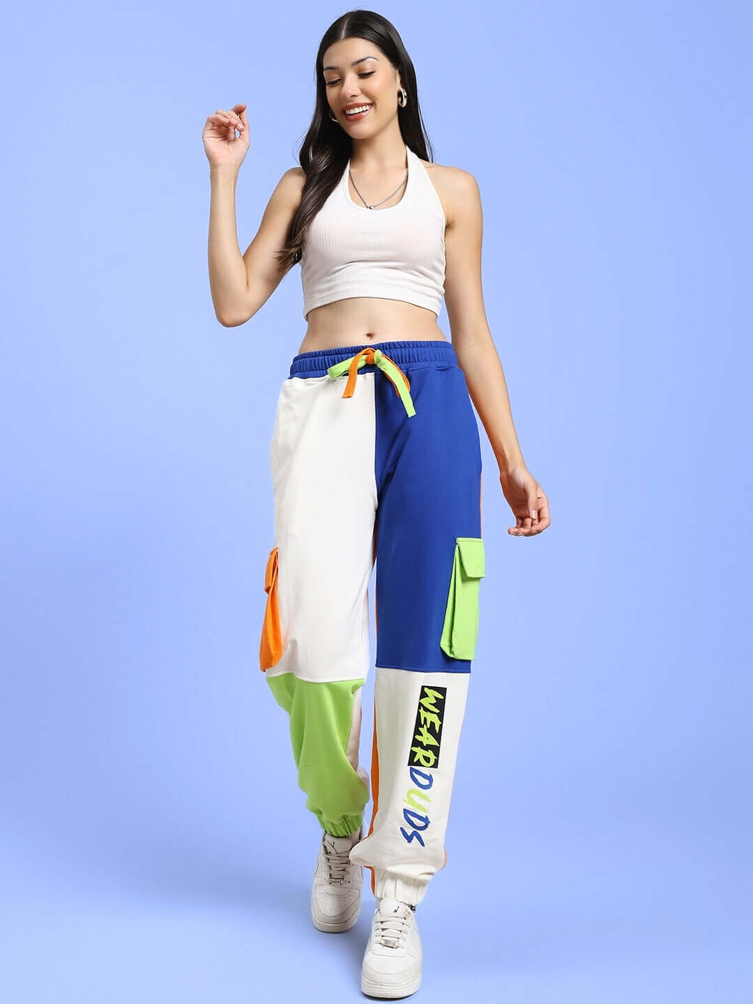 Woman wearing women's multi-pocket colorblock joggers with a relaxed fit, featuring vibrant blue, green, and orange accents.