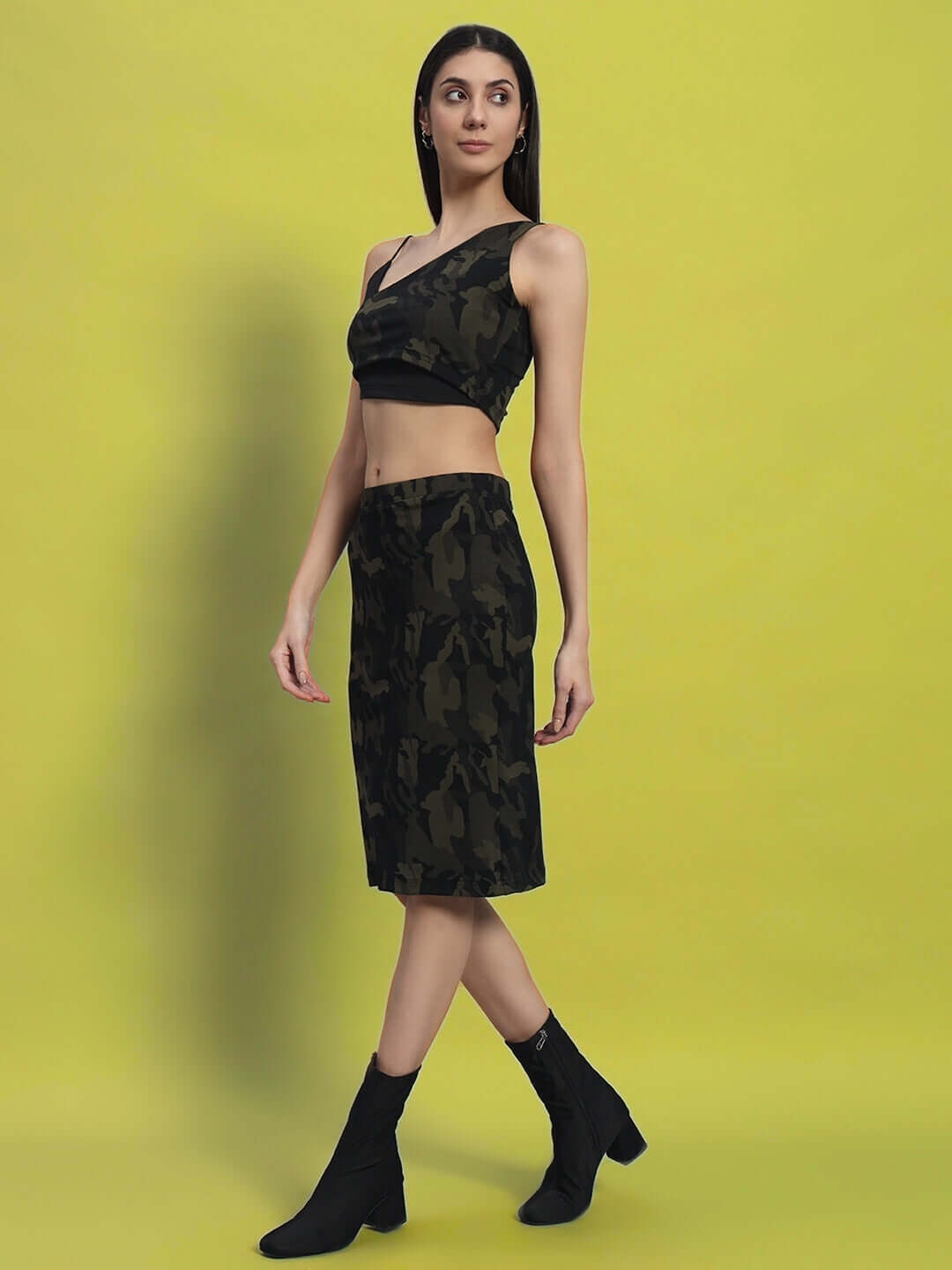 Model wearing WOMEN'S NAIROBI CO-ORD SET CAMO GREEN from WEAR DUDS, featuring a stylish camo print on a bright yellow background.