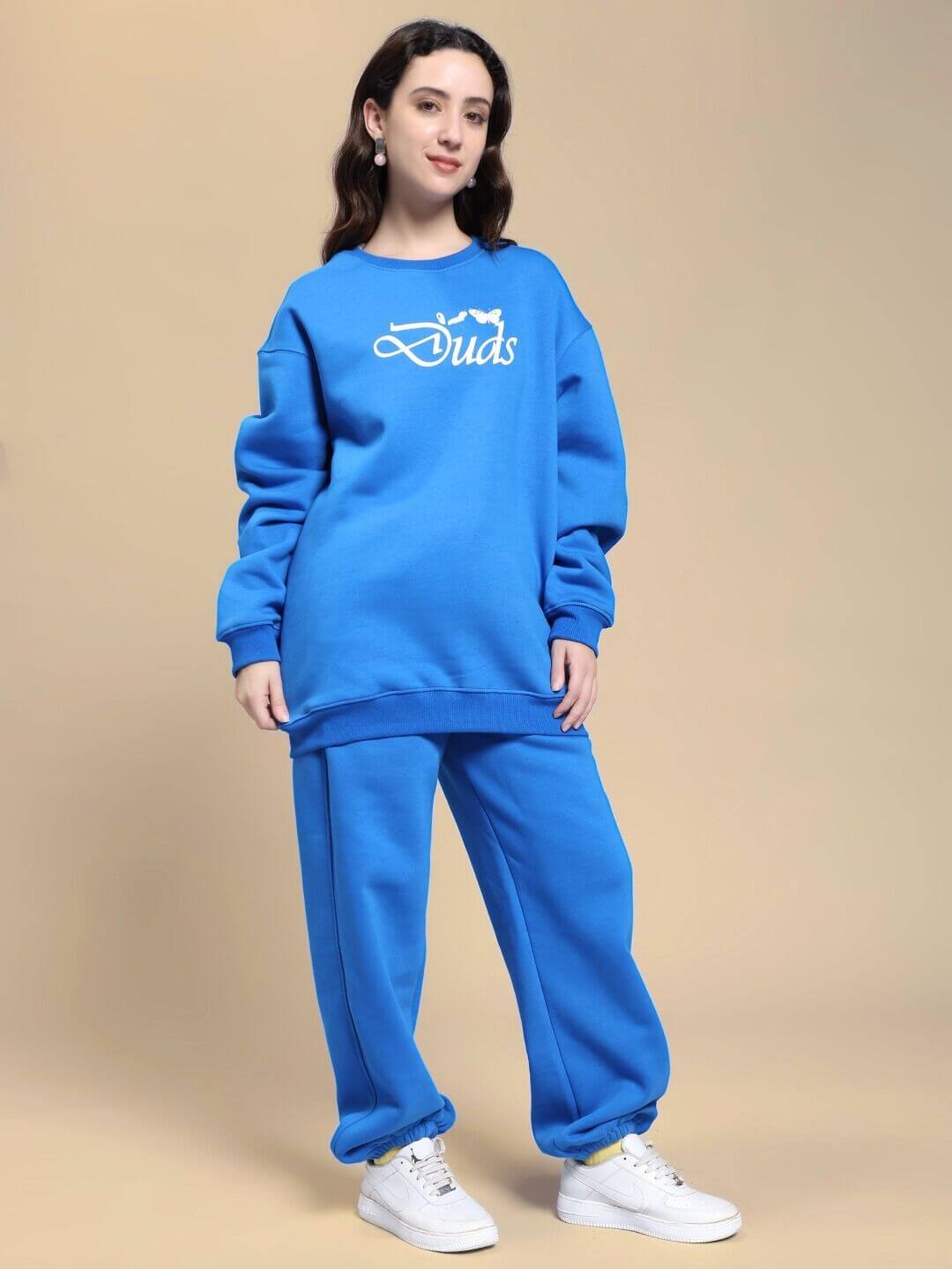 Model wearing WOMEN NATURE LINK FLEECE CO-ORD SET ROYAL BLUE, showcasing the vibrant and cozy design of sweatshirt and joggers set.