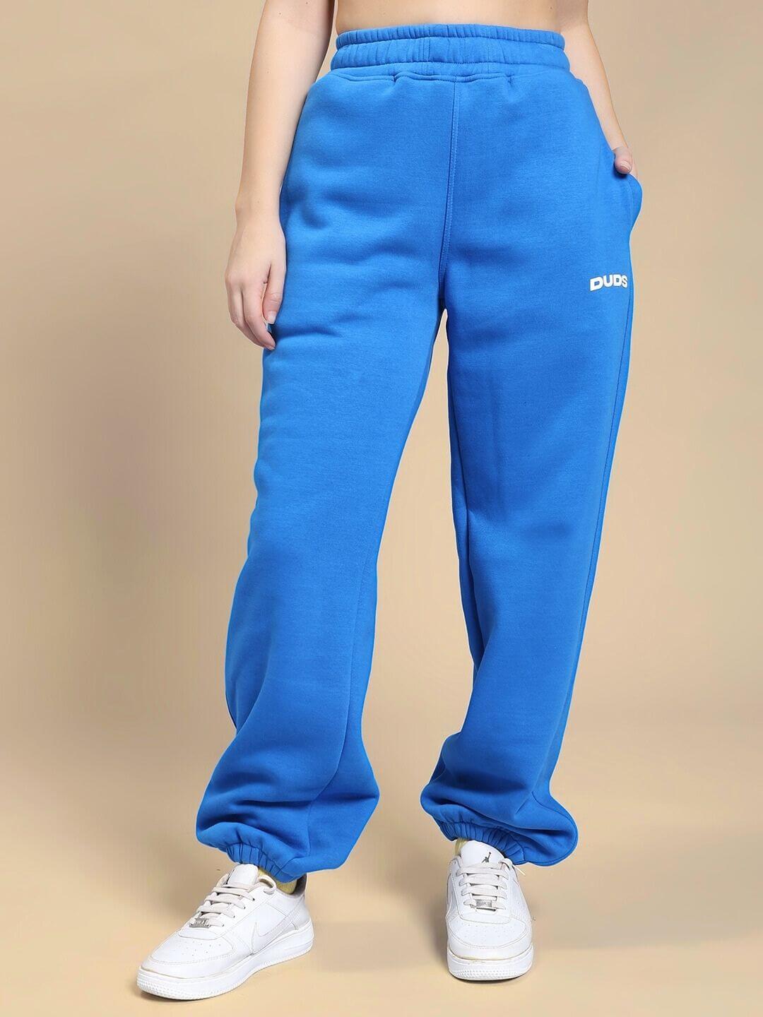 Model wearing WOMEN NATURE LINK FLEECE CO-ORD SET ROYAL BLUE joggers, showcasing vibrant color and cozy fleece fabric.
