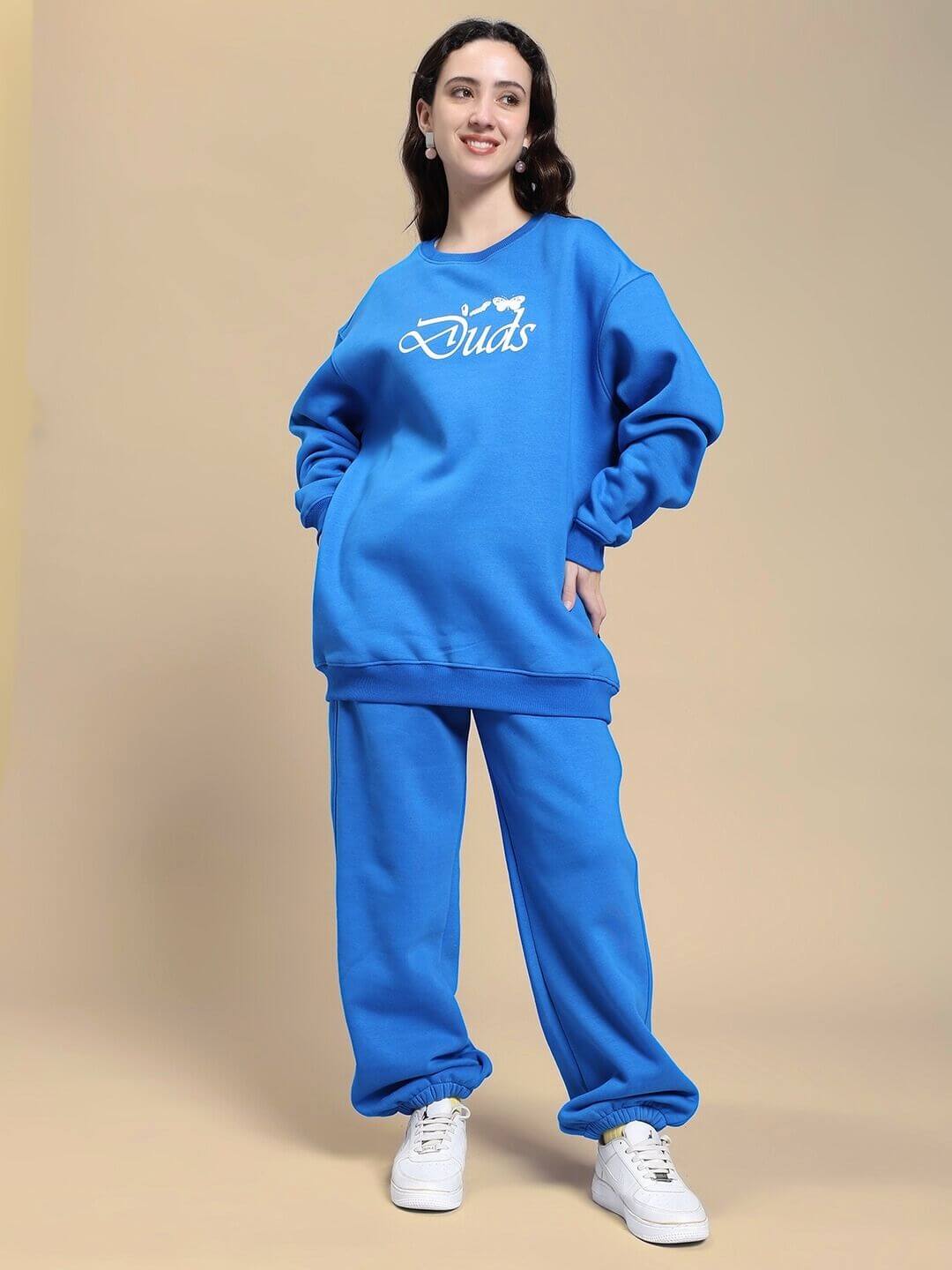 Model wearing WOMEN NATURE LINK FLEECE CO-ORD SET ROYAL BLUE, showcasing plush fleece sweatshirt and joggers in vibrant blue