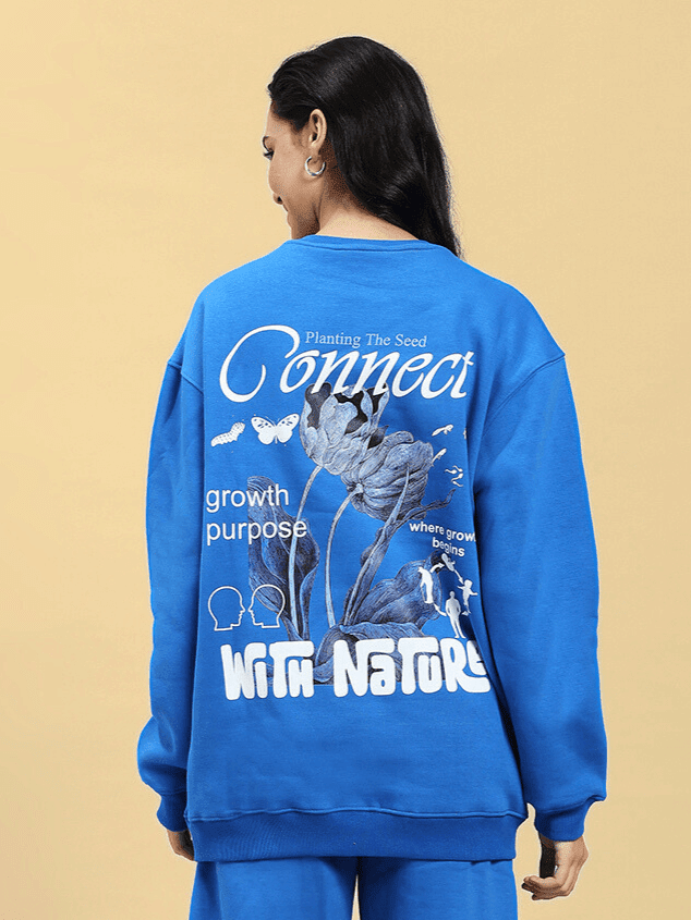 Back view of WOMEN NATURE LINK FLEECE SWEATSHIRT ROYAL BLUE with nature-inspired design and text, showcasing cozy fleece fabric.
