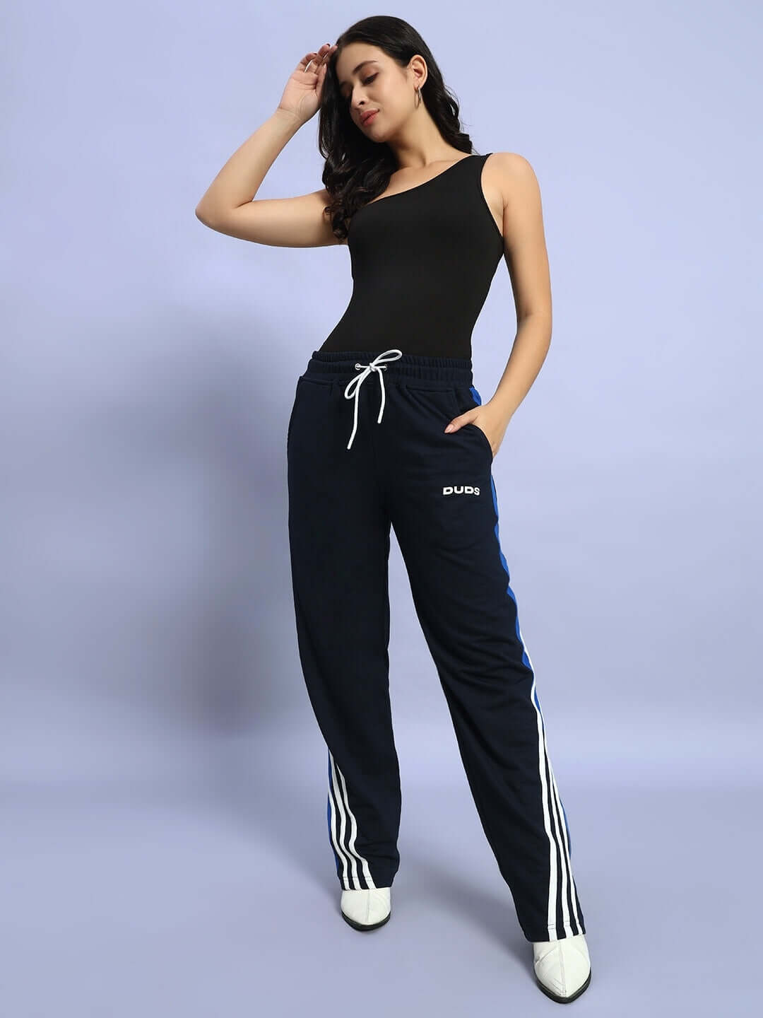 Woman wearing navy blue Women's Tangle Relaxed-Fit Joggers by DUDS, showcasing side stripes and a relaxed fit for comfort and style.