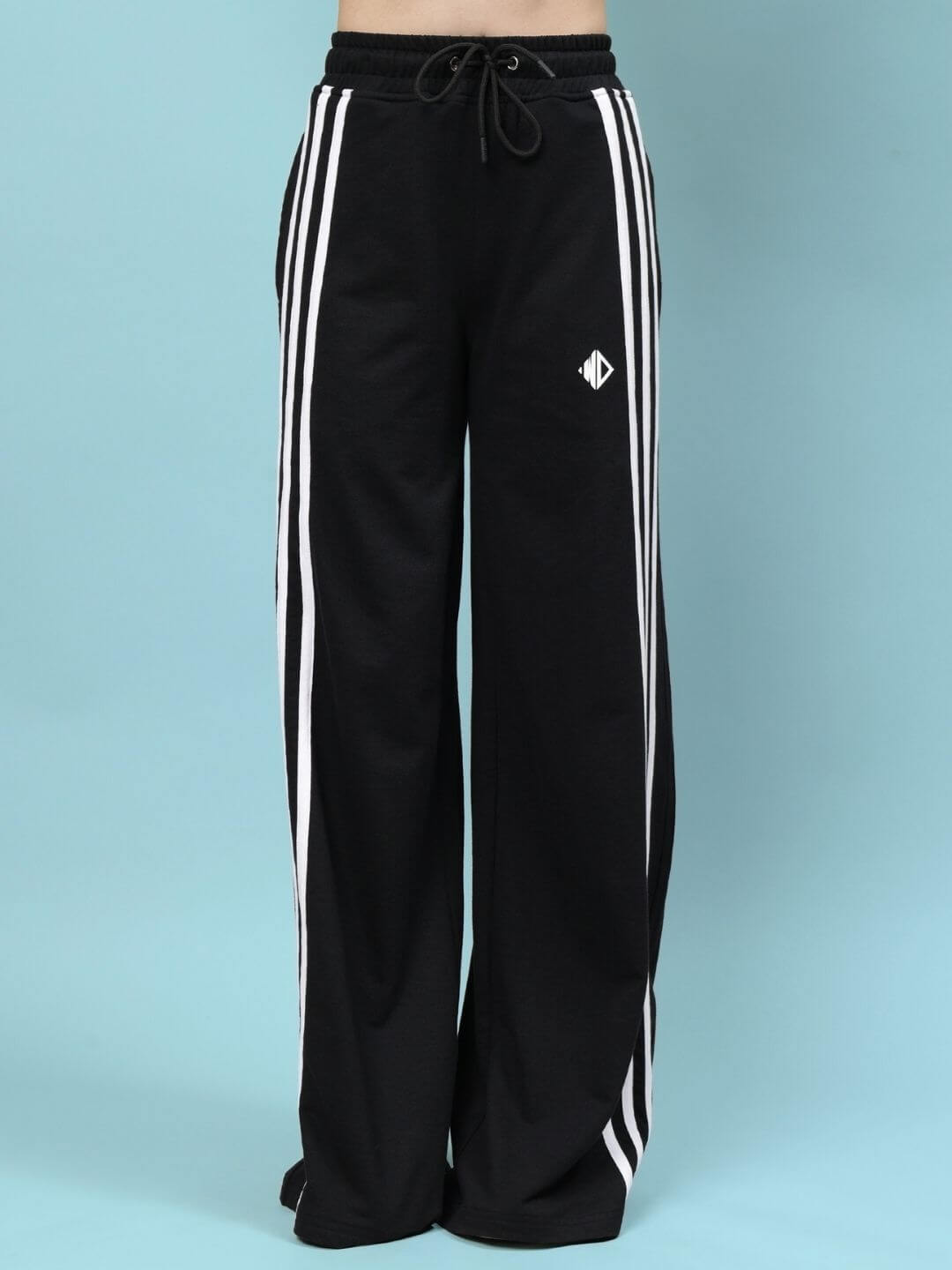 Women's black relaxed-fit joggers by DUDS with white side stripes, showcasing a comfortable, made-to-order design.