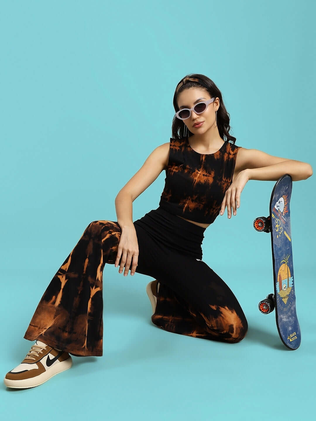Model wearing Women's Nina Tie-Dye Co-Ord Set in black, styled with a skateboard, showcasing modern casual fashion.