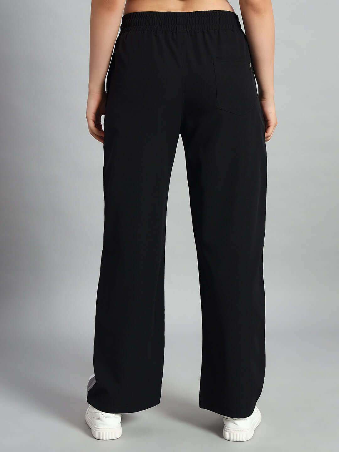 Back view of women's black relaxed fit cargo pants, showcasing waistband and casual style.