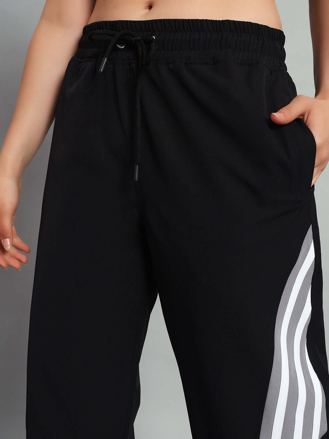 Women's black relaxed fit cargo pants with customizable size option, featuring drawstring waist and side stripes for casual style.