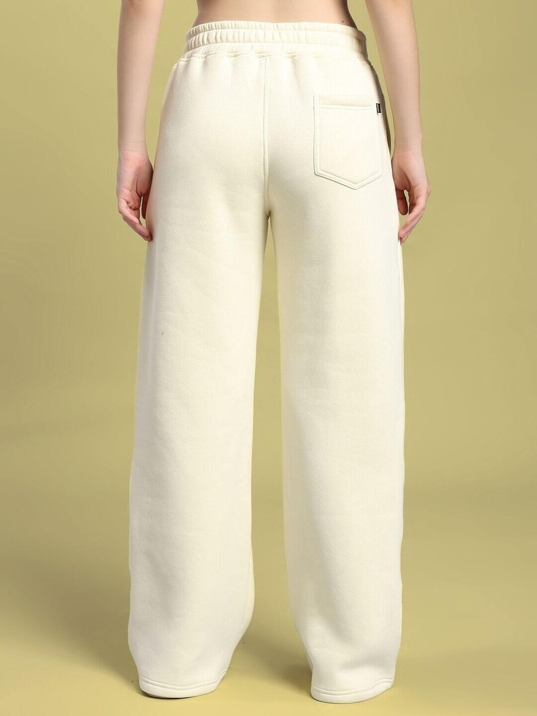 Back view of WOMEN'S OCEAN BUDDIES JOGGER OFF-WHITE, showcasing relaxed fit and pocket detail in soft cotton-poly fabric.