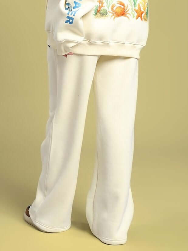 Model wearing WOMEN'S OCEAN BUDDIES JOGGER OFF-WHITE with sea life graphic, showcasing comfortable and stylish design.