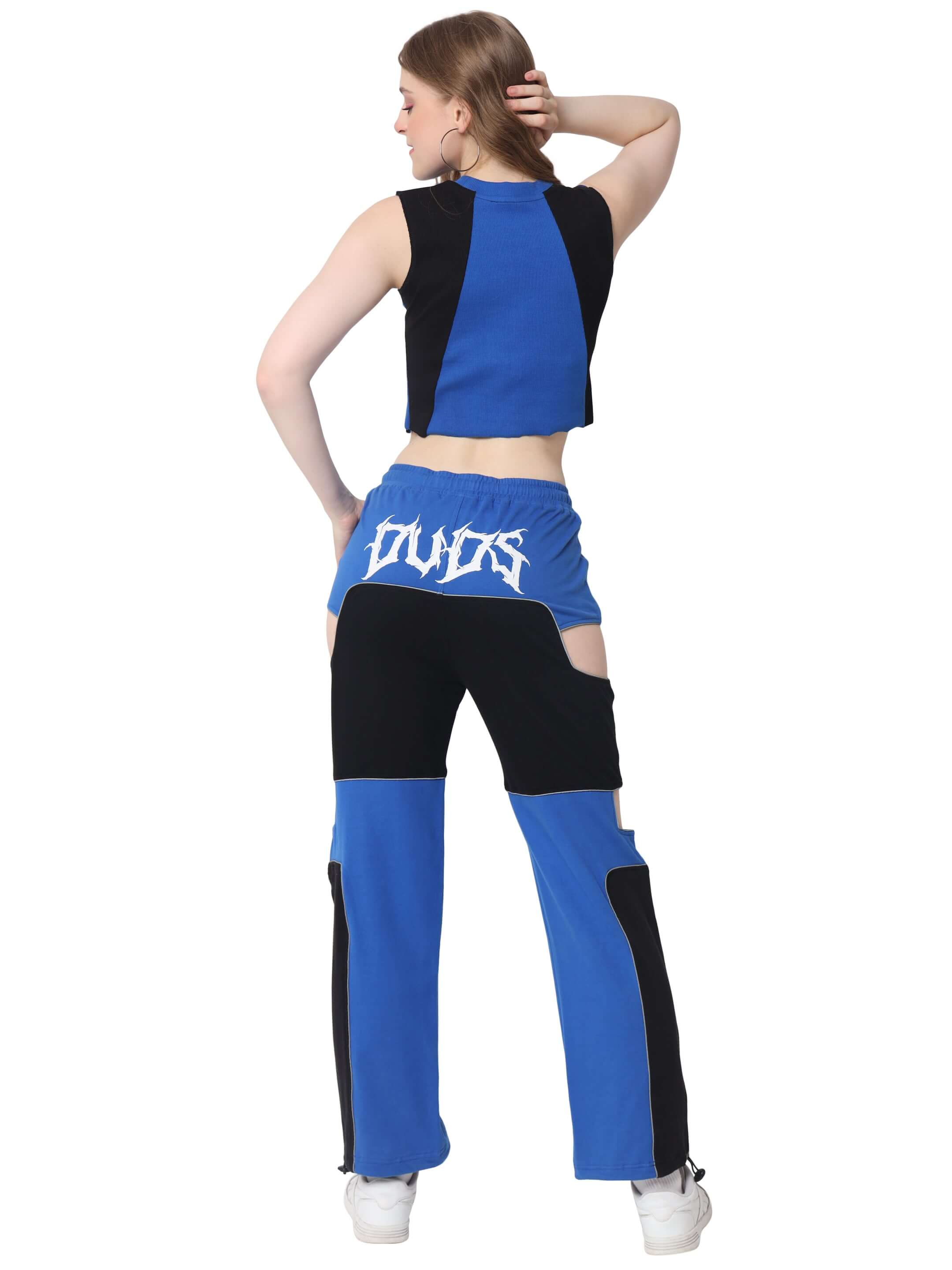 Back view of women's blue Oddy co-ord set with black accents made of 100% premium cotton, styled with casual white sneakers.
