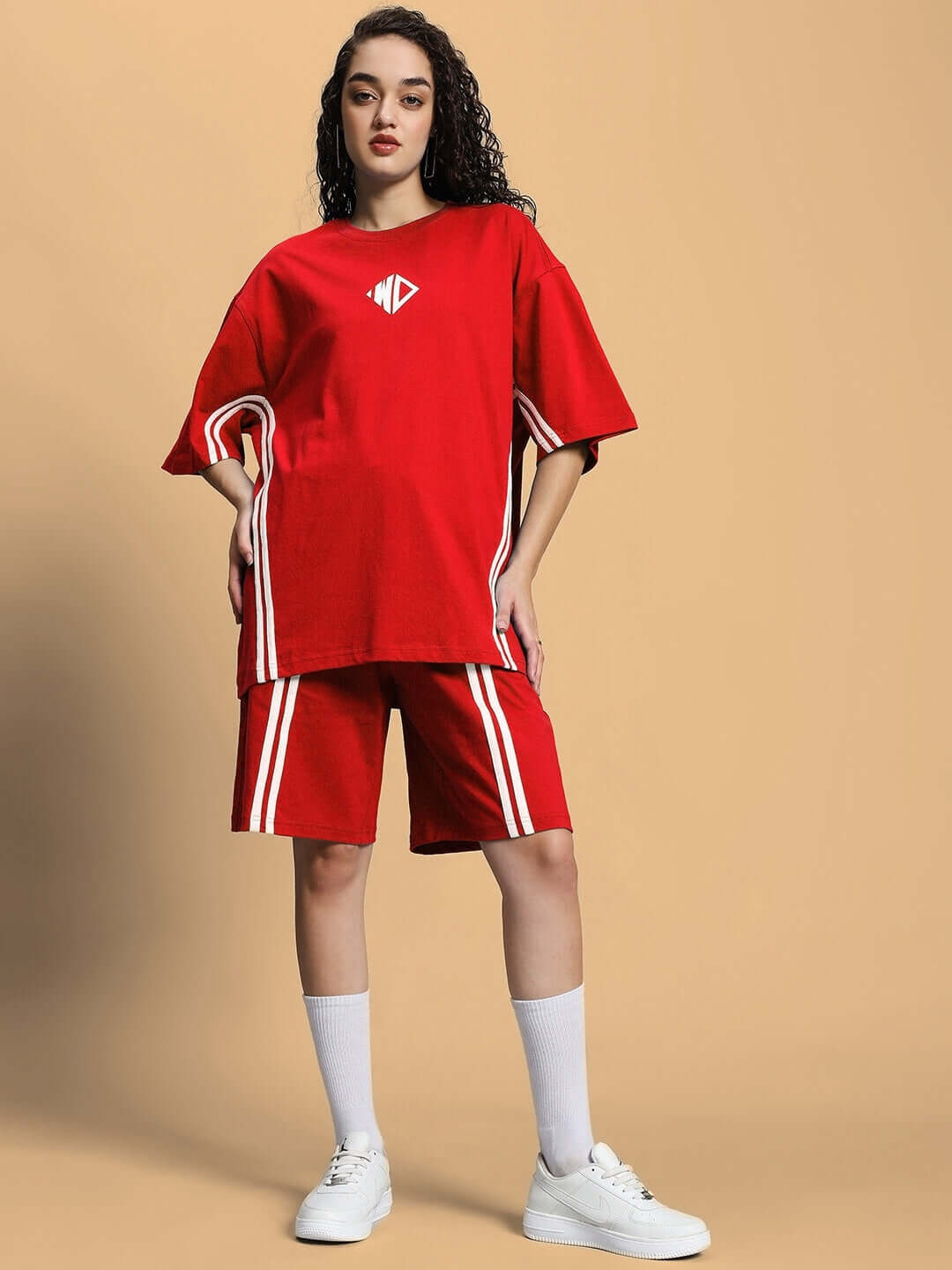 Model wearing WOMEN'S OUTLOOK SUMMER CO-ORD SHORTS SET RED with relaxed-fit t-shirt and shorts, showcasing vibrant red color.