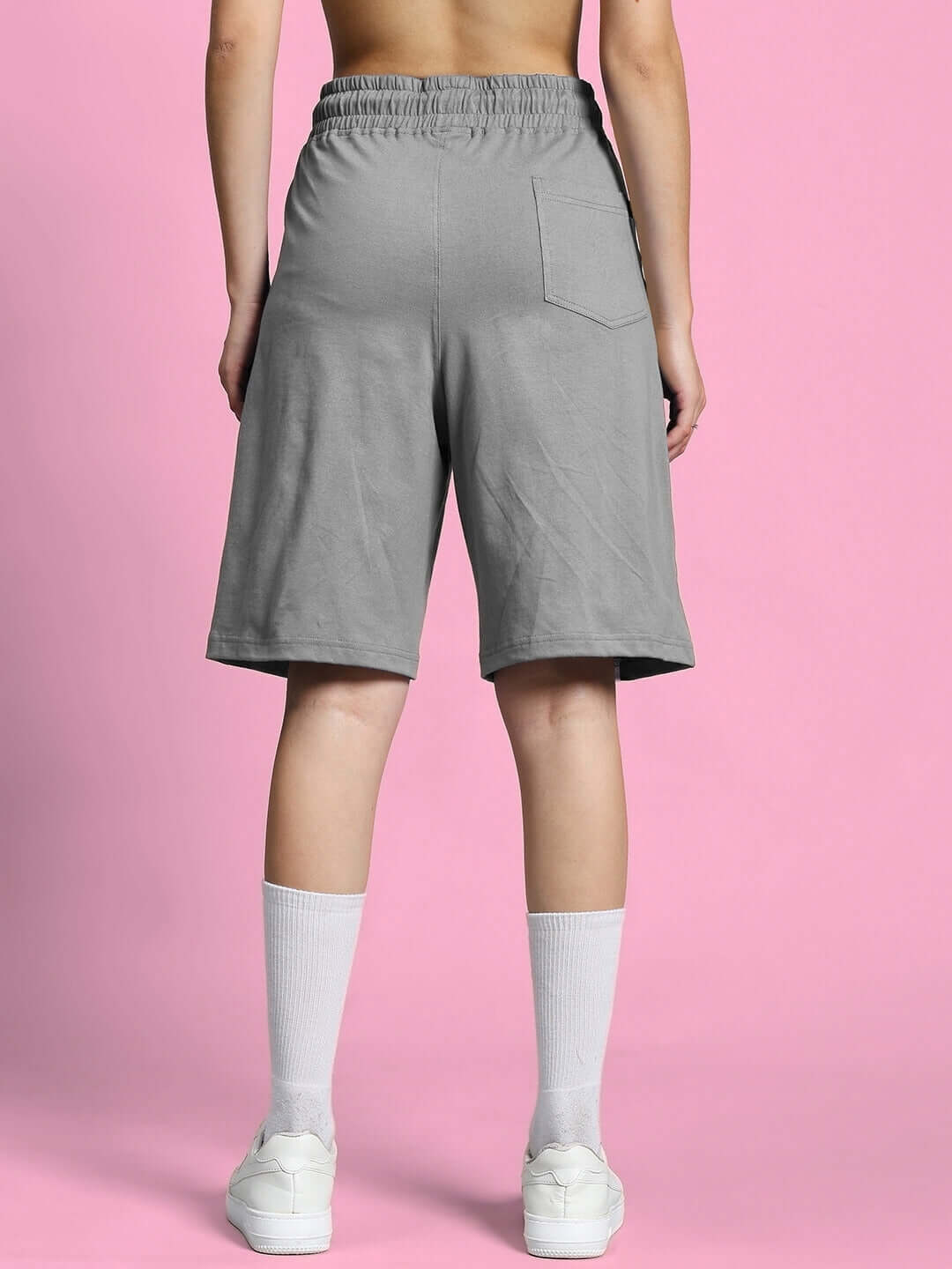 Back view of WOMEN'S OUTLOOK SUMMER CO-ORD SHORTS SET GREY showcasing comfortable fit and style against a pink background.
