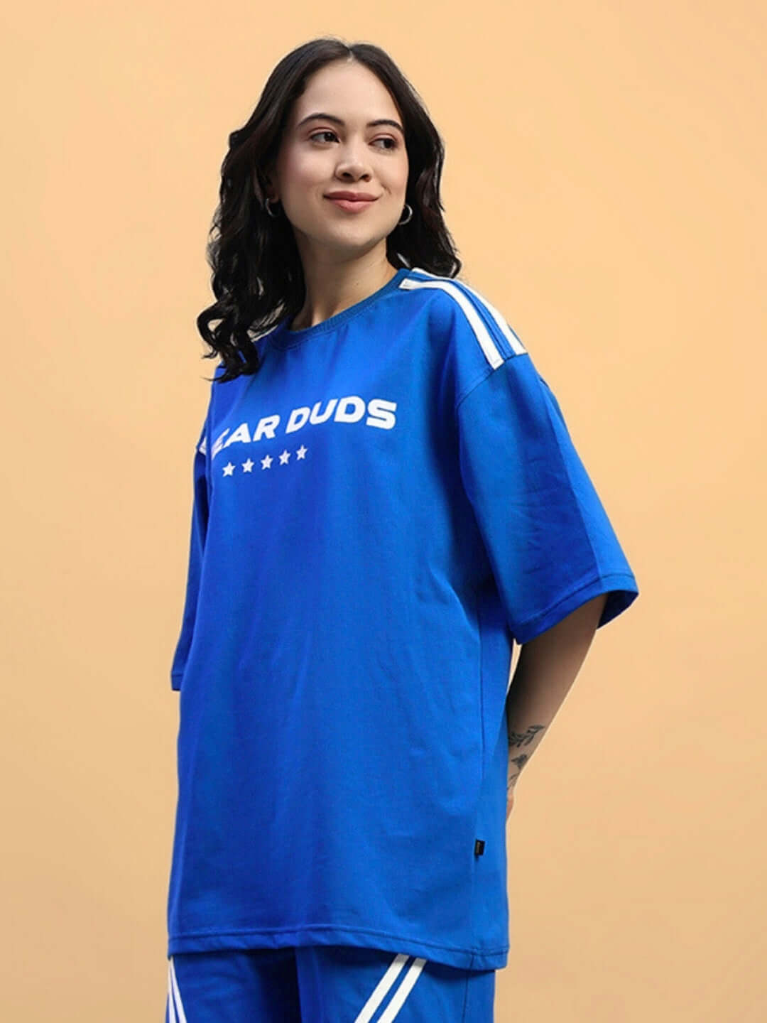 Model wearing Women's Star Jumper oversized blue T-shirt made from premium cotton fabric, showcasing casual fashion style.