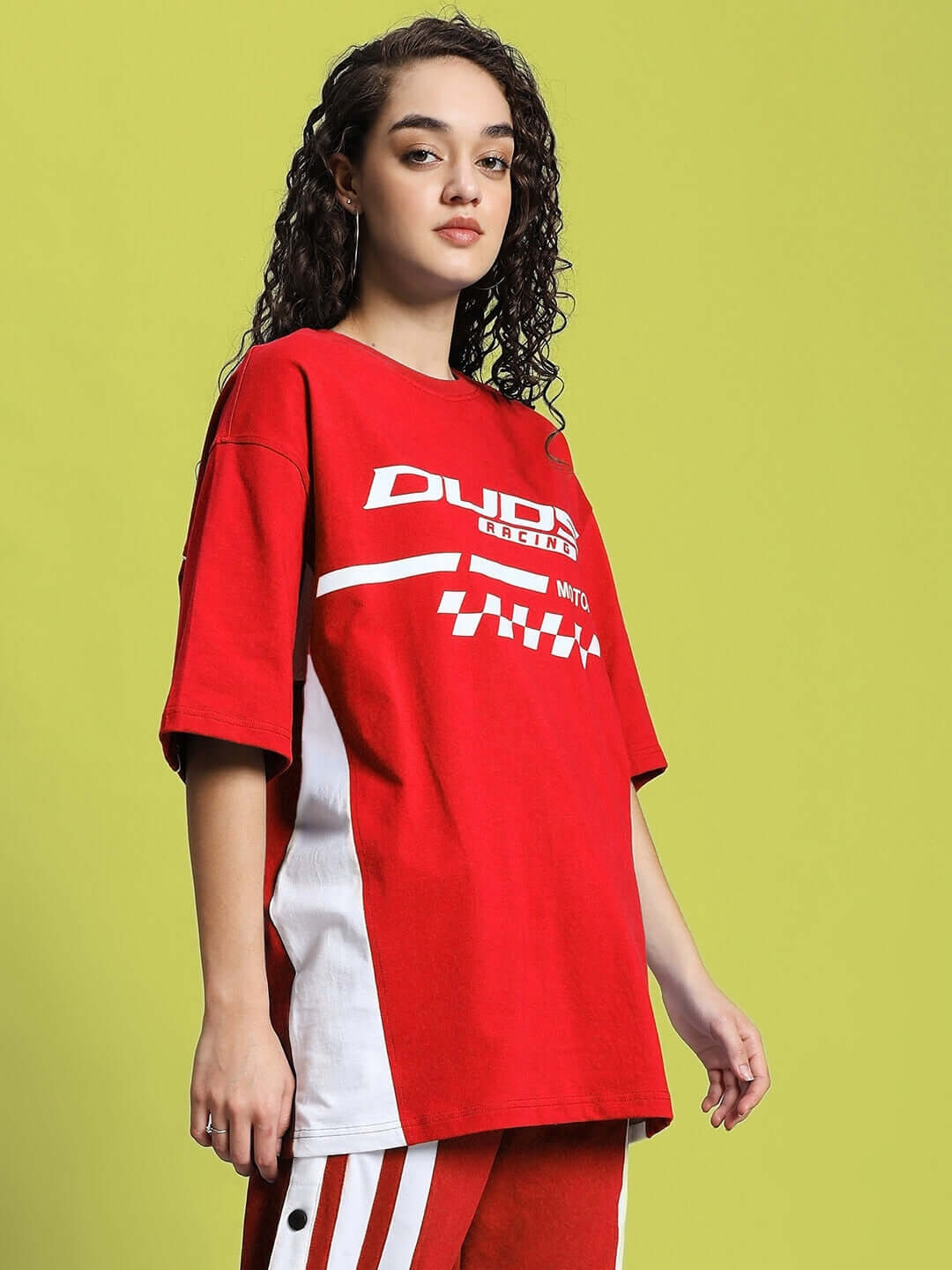 Model wearing women's oversized classic red t-shirt, front view, made of premium cotton fabric, styled with white accents.