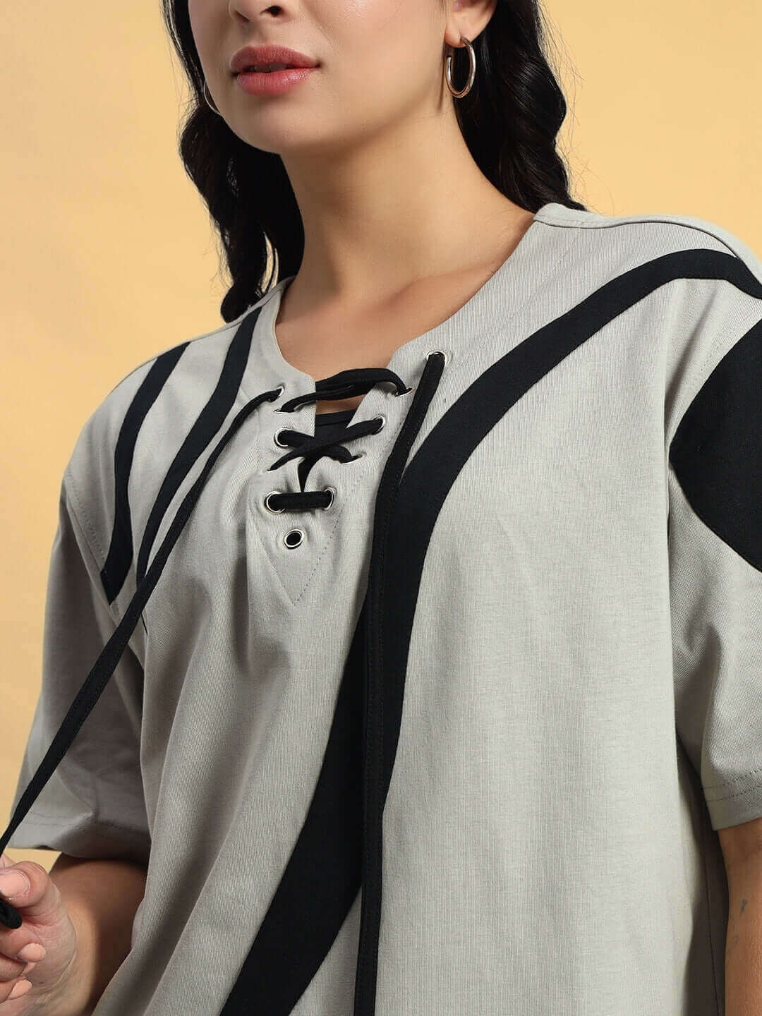 Women's grey oversized surfing t-shirt with designer lace-up detail, premium cotton blend, modeled against a neutral background.
