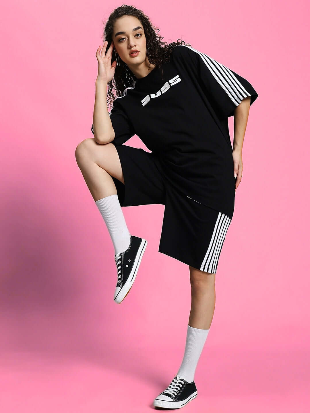 Model wearing WOMEN'S PARKA SUMMER CO-ORD SET BLACK in stylish pose on pink background