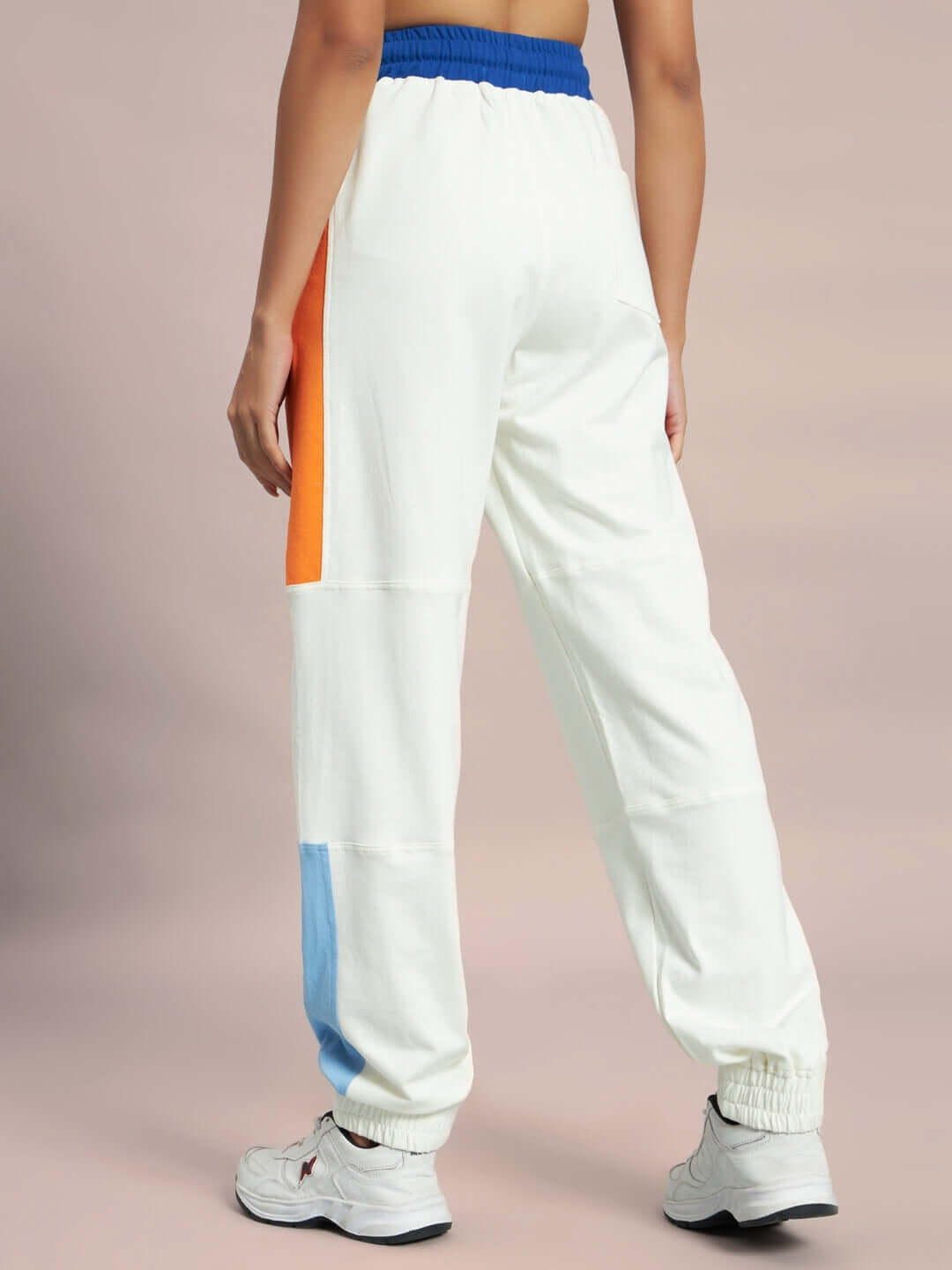 Women's Parker Side Contrast Joggers in Off-White with vibrant side panels, worn by model, showcasing unique tailored design.