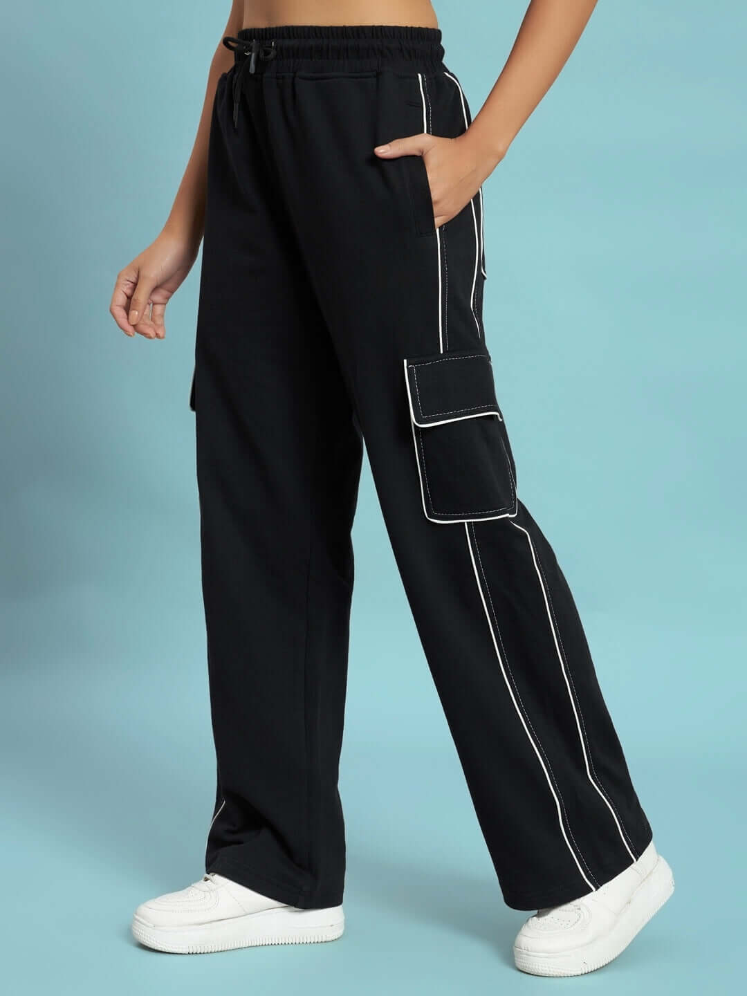 Model wearing women's black pedal contrast stitch cargo pants with pockets by DUDS, featuring a comfortable fit and white sneakers.
