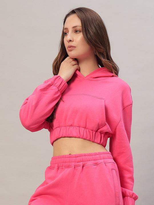 Woman wearing WOMEN CHARM OVER-SIZED FLEECE CROP HOODIES PINK, showcasing relaxed fit and soft fabric.