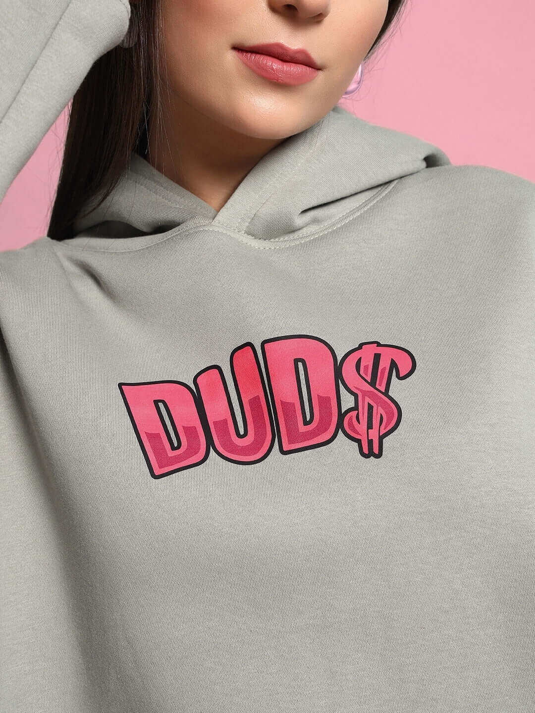 Close-up of WOMEN PINK PANTHER OVERSIZED HOODIE GREY with 'DUD$' logo design.
