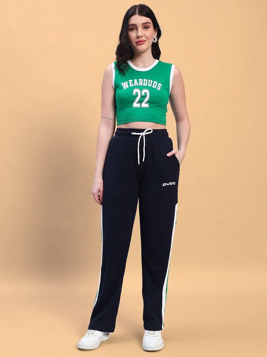 Model wearing WOMEN'S PLAYER CO-ORD SET GREEN NAVY with sporty green top and navy pants.