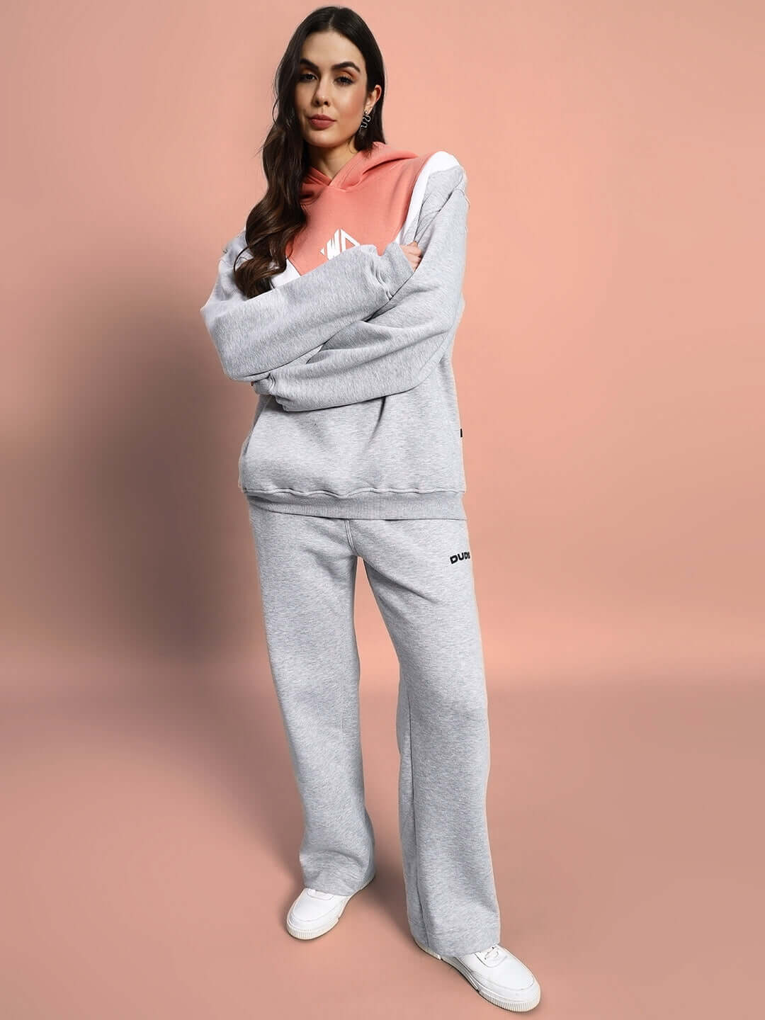 Woman wearing WOMEN POLAR COLORBLOCK CO-ORD GREY PEACH, cozy and stylish athleisure set with hoodie and pants, perfect for casual outings.