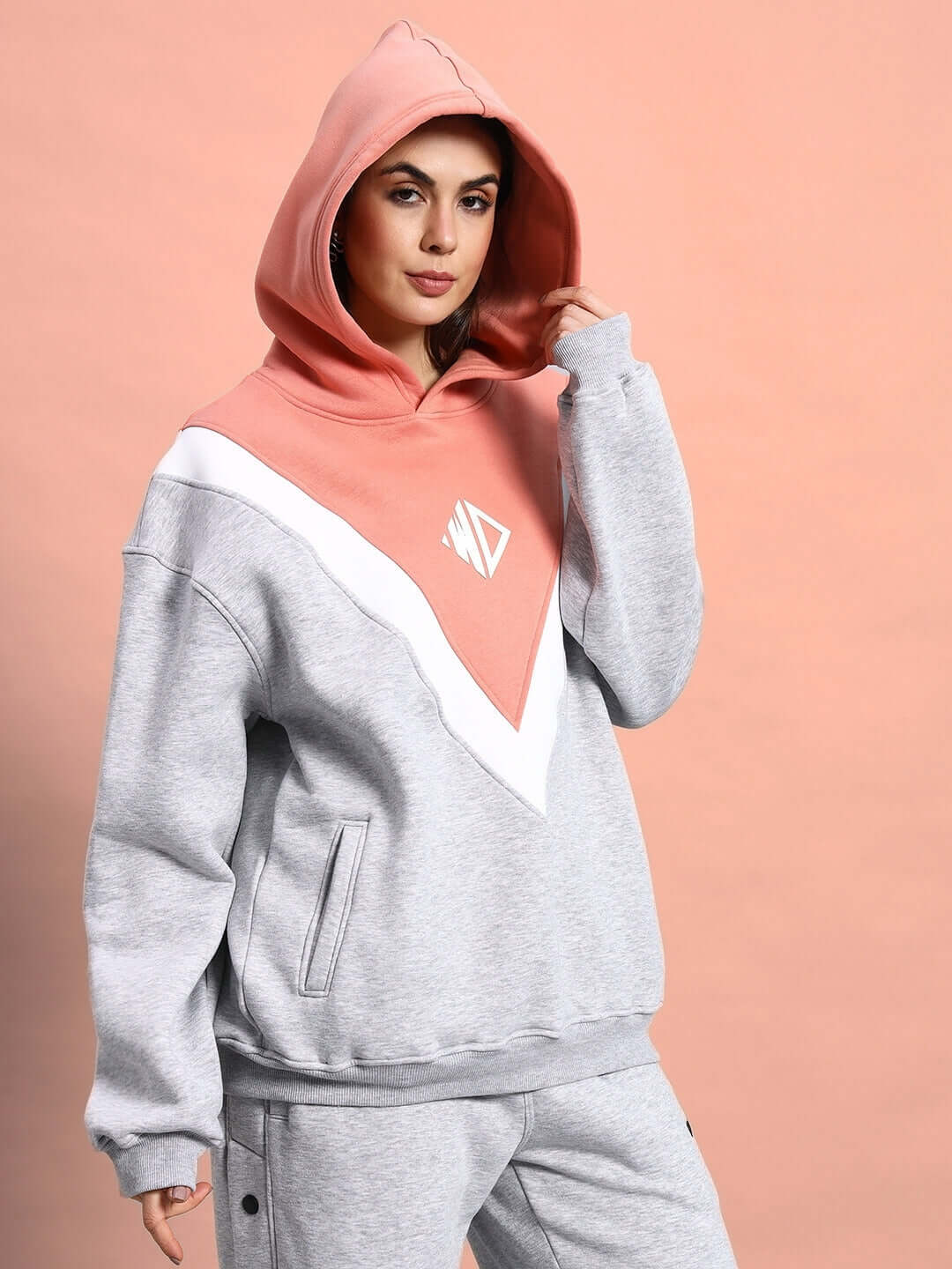 WOMEN POLAR COLORBLOCK HOODIE GREY PEACH in premium fleece, showcasing a chic grey and peach design for warmth and style.