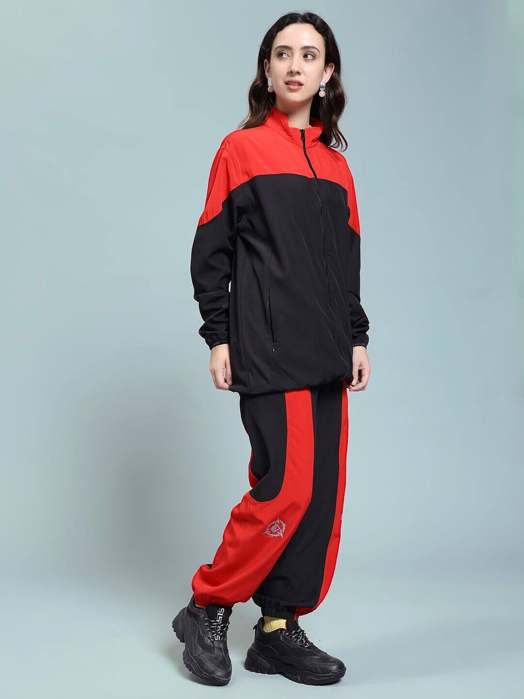 Woman wearing WOMEN POWER BLOCK CO-ORD SET BLACK RED outfit, showcasing sporty and sleek design in black and red color block pattern.