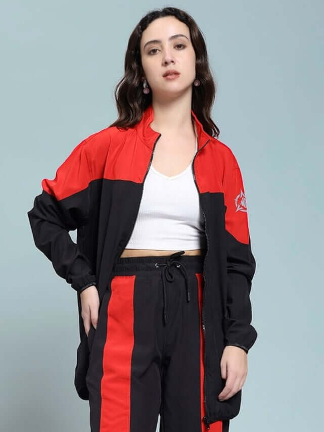 Woman wearing WOMEN POWER BLOCK RELAXED FIT JACKET BLACK RED with sporty black and red design.