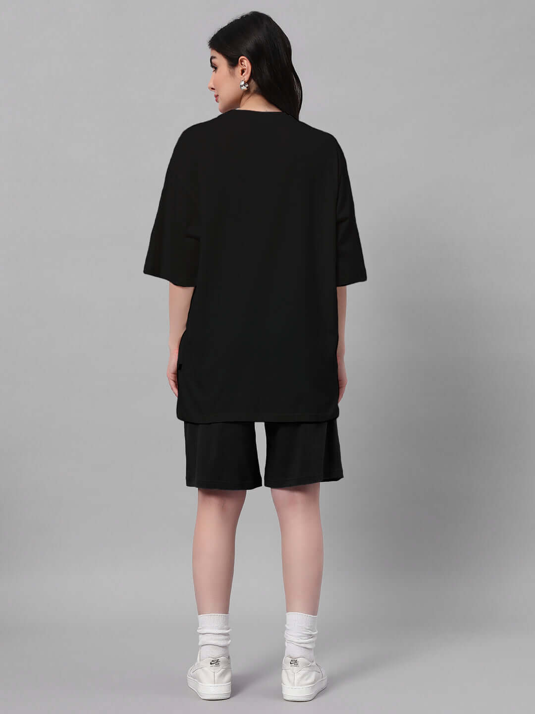Rear view of a model wearing the Women's Quack Off Co-ord Set in black, featuring a premium cotton and elastane blend for a comfortable fit.