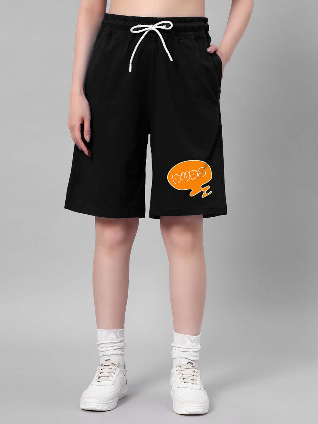 Women's black co-ord set shorts with orange graphic detail, made from 97% premium cotton and 3% elastane. Cold machine wash recommended.