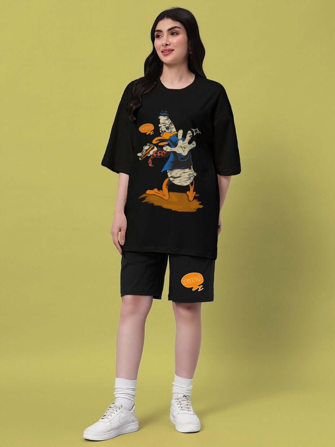 Woman wearing black summer shorts with graphic tee, showcasing DUDS' Quack Off collection for women, customized fit available.