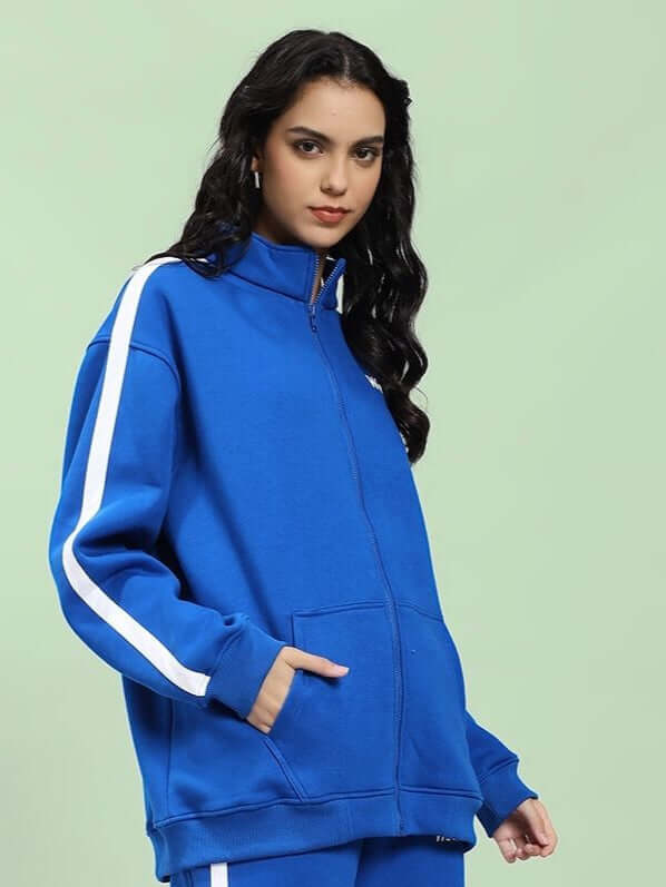 Model wearing WOMEN RAPID STRIDE COTTON FLEECE JACKET ROYAL BLUE, showcasing its sporty design and vibrant color.