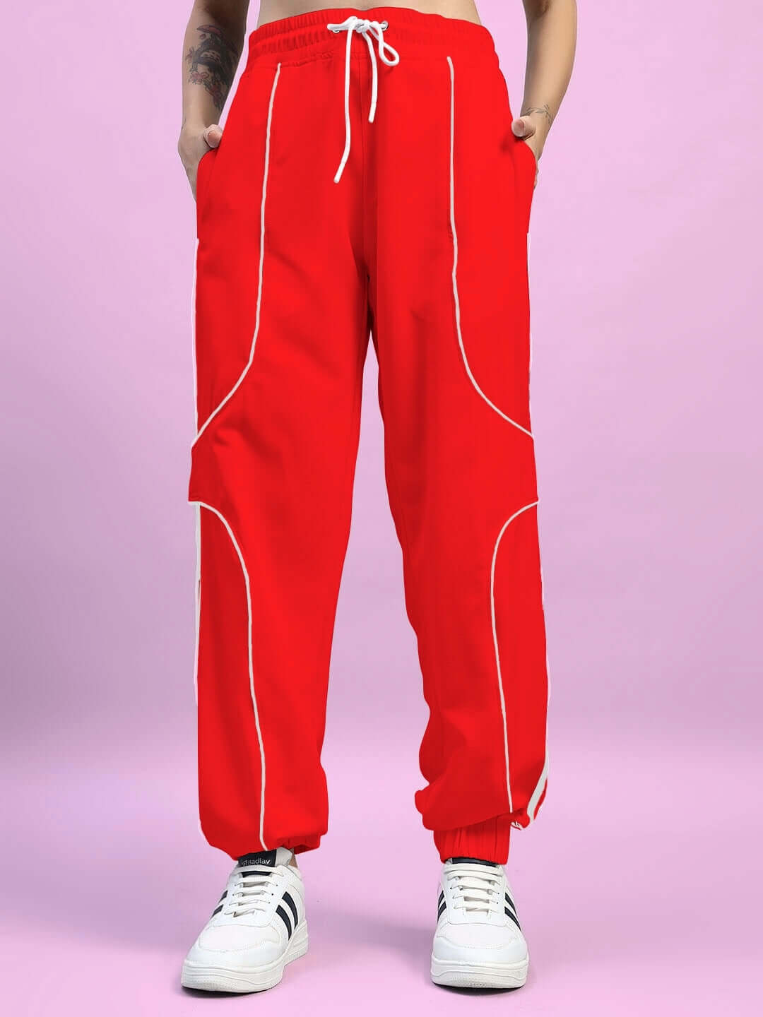 Women's red joggers with white stripes, relaxed-fit design, featuring drawstring waist and pockets for style and comfort.