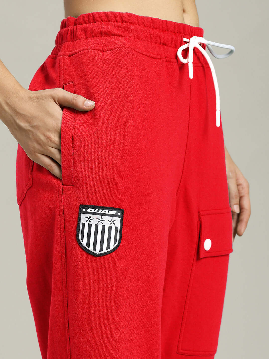 Close-up of WOMENS AWESOME FLAP POCKET BAGGY JOGGER RED with flap pocket and drawstring detail.