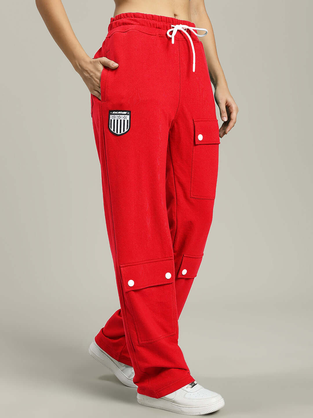 Woman wearing WOMENS AWESOME FLAP POCKET BAGGY JOGGER RED, showcasing relaxed fit and trendy design.